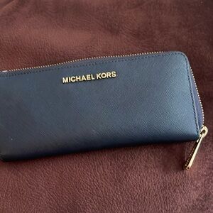 Navy blue Michael kors wallet zip with card slot on both sides and coin zip gold